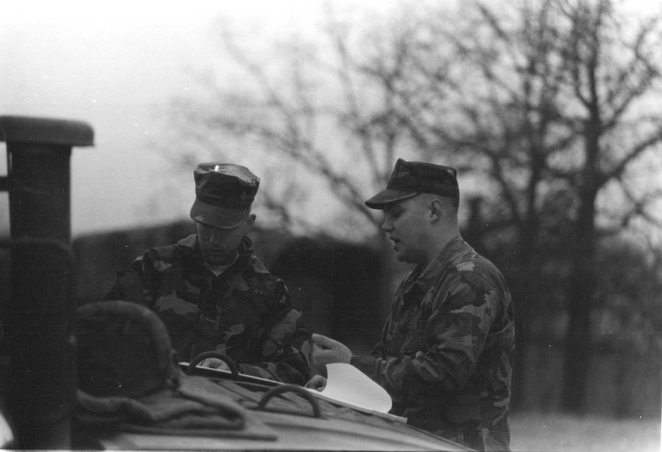 A young Marine at a vehicle in the field — Tom during his Marine Corps service.