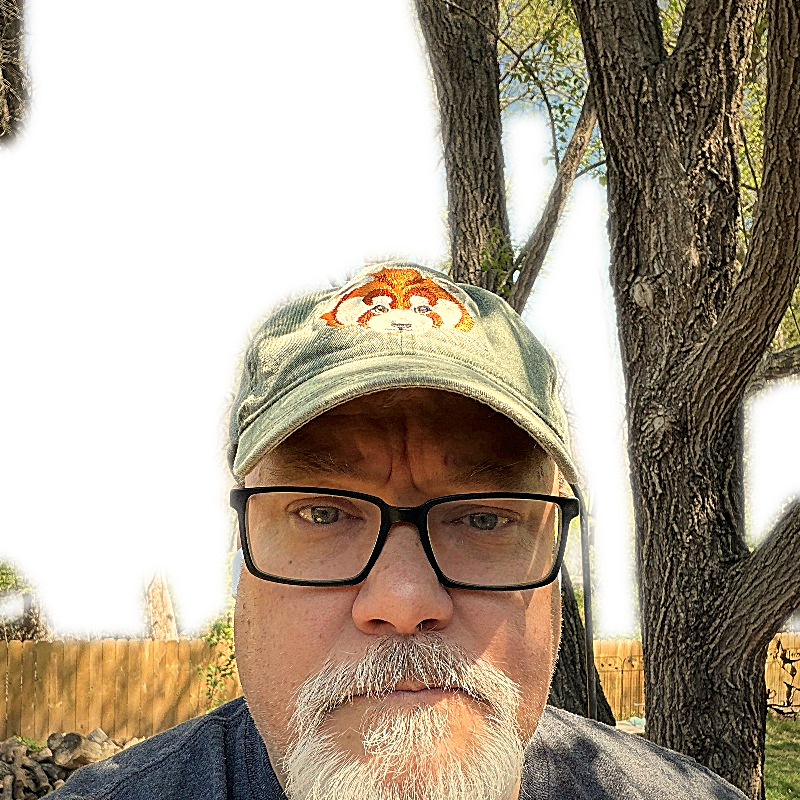 Tom outdoors in a green cap