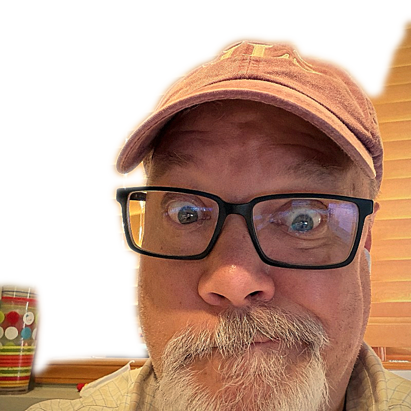 Tom wide-eyed in a red cap